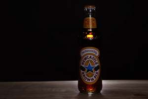 The Newcastle Brown Ale has a flavor that is balanced out by sweet and bitter notes, and would pair well with a burger.