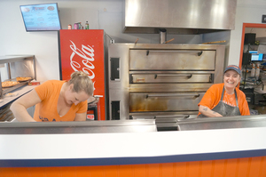 Employees at M-Street Pizza make pizza for hungry Syracuse University students.